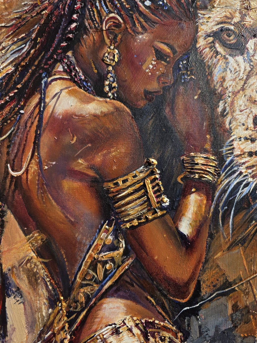 Close-up of Queen Tsandzile's face, gold earrings and raised gold arm cuffs as she leans into the lion – African queen painting by Jedidah Chick