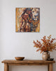 Queen Tsandzile Ndwandwe lion painting on a white wall above a rustic wooden console with a vase of autumn leaves
