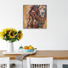 Queen Tsandzile Ndwandwe lion painting above a dining table with sunflowers and a bowl of oranges