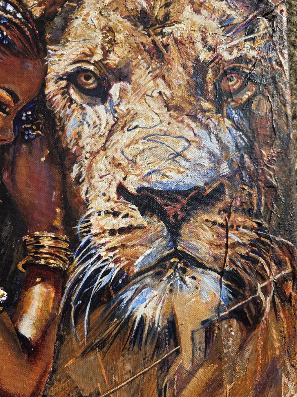 Close-up of the lion's face in the Queen Tsandzile Ndwandwe painting, with a textured golden mane and amber eyes