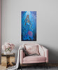 Mermaid art, underwater painting, African Queen Mwana Kupona of Kenya., textured art, African artwork hanging on a wall above a pink sofa and pink flowers on a table.
