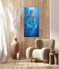 Room interior with mermaid art, underwater painting, African Queen Rasi ya Mwana of Kenya. textured art, African artwork abstract painting above  a beige armchair, and decorative vases.