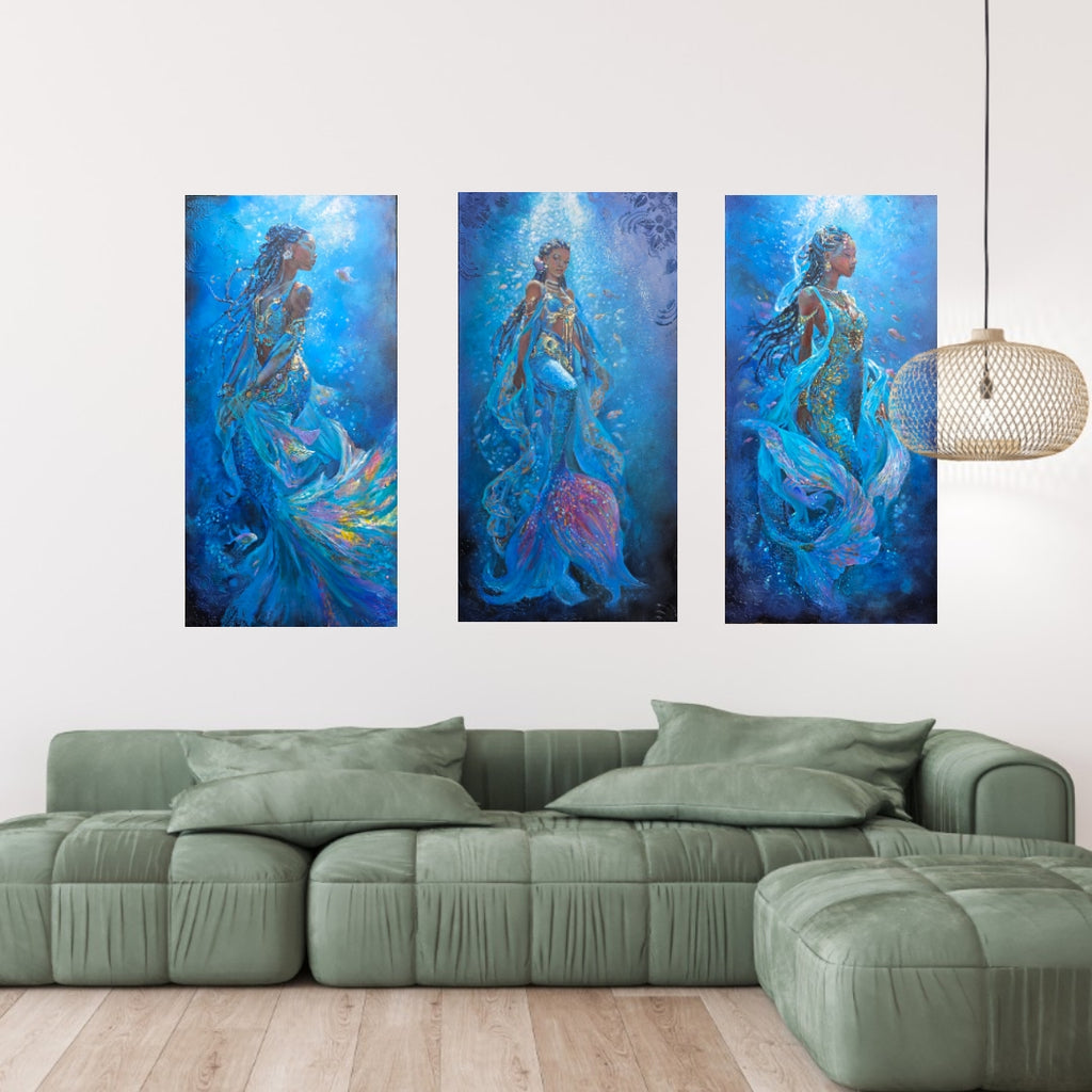 A 3-piece collection of mermaid art, underwater painting, textured art, African art work, inspired by  Swahlli history hung over a green sofa in a modern living room setting.
