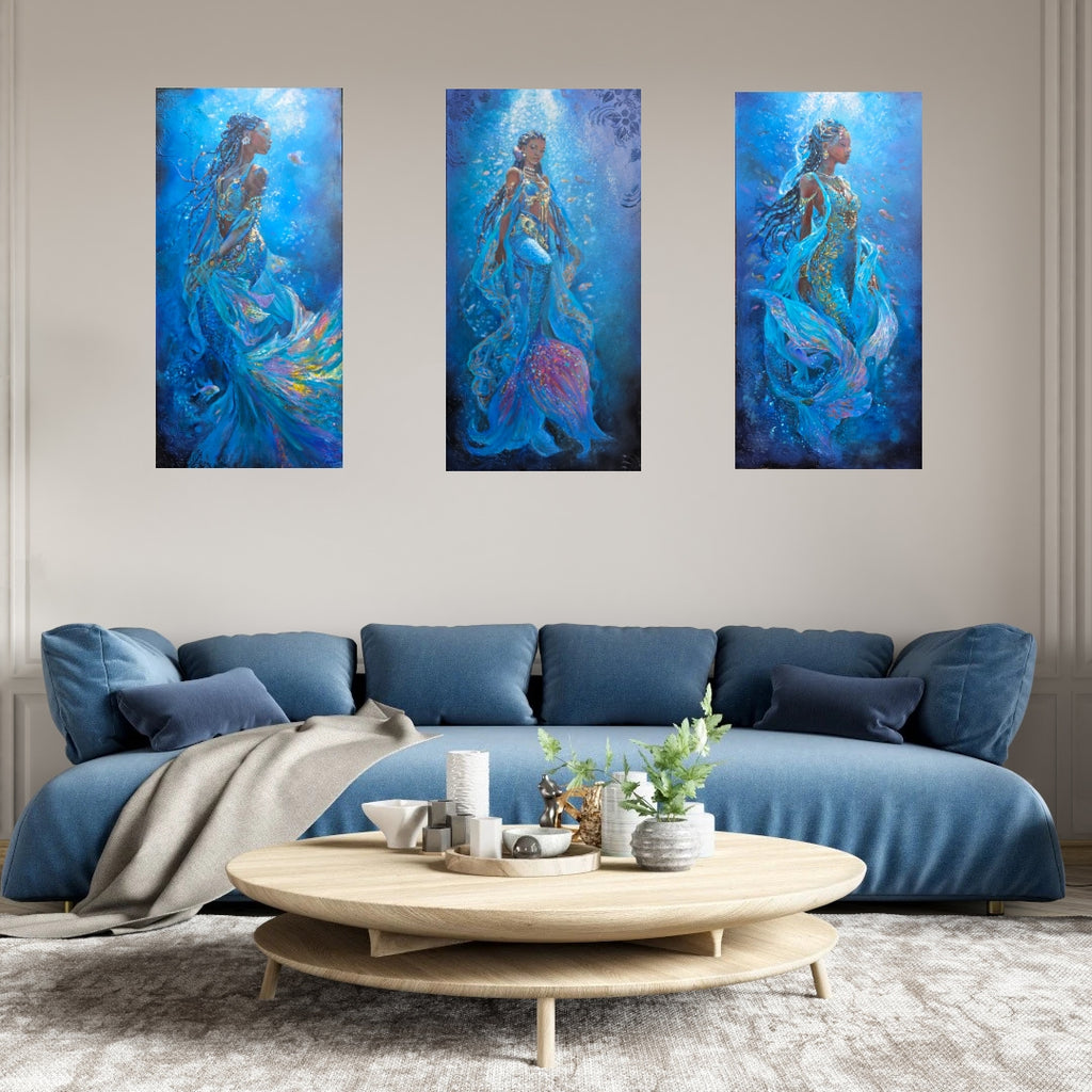 A 3-piece collection of mermaid art, underwater painting, textured art, African art work, inspired by  Swahlli history hung over a sofa in a modern living room setting.